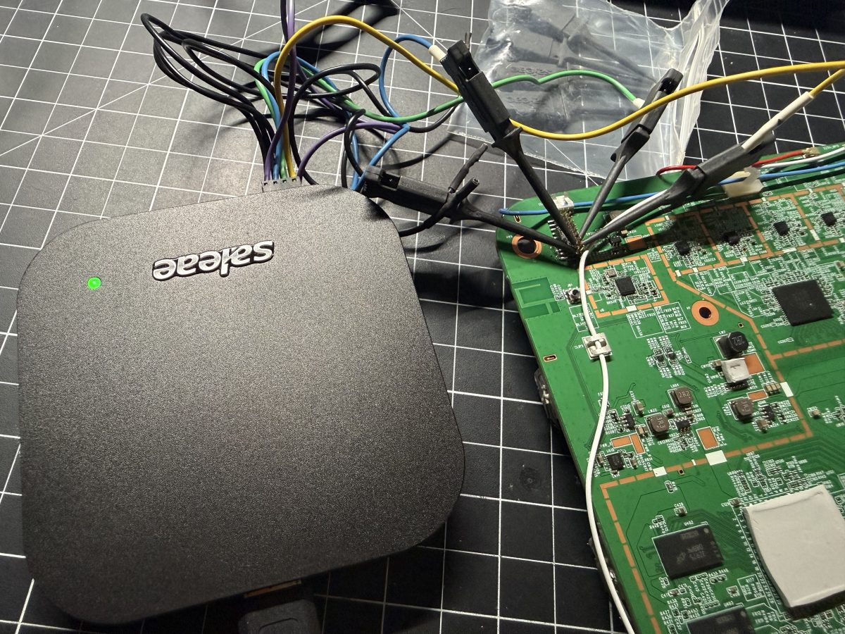 A Saleae Logic analyzer clipped onto the W1700K board to probe the AN7581-to-MG21 UART