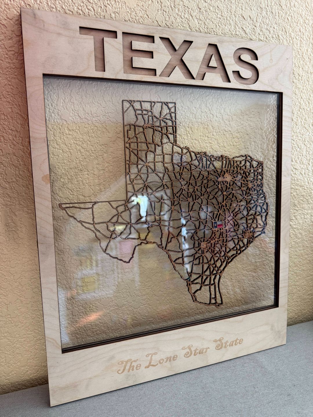 Framed layered map wall art showing real-world placement