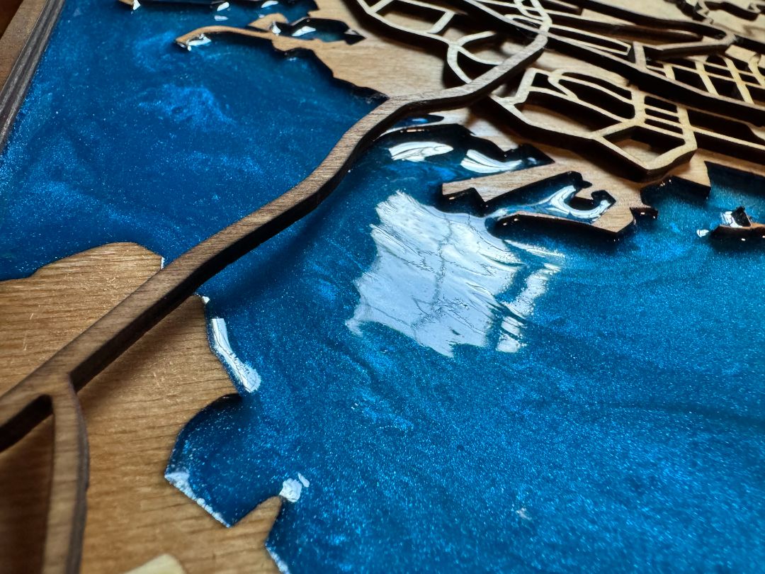 Layered wood map with resin showing depth and material detail